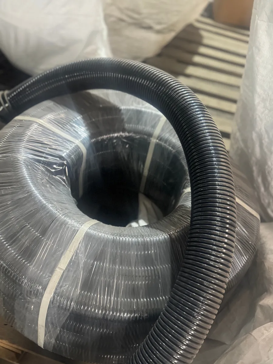 Flexible conduit coil stretch-wrapped and strapped for dispatch